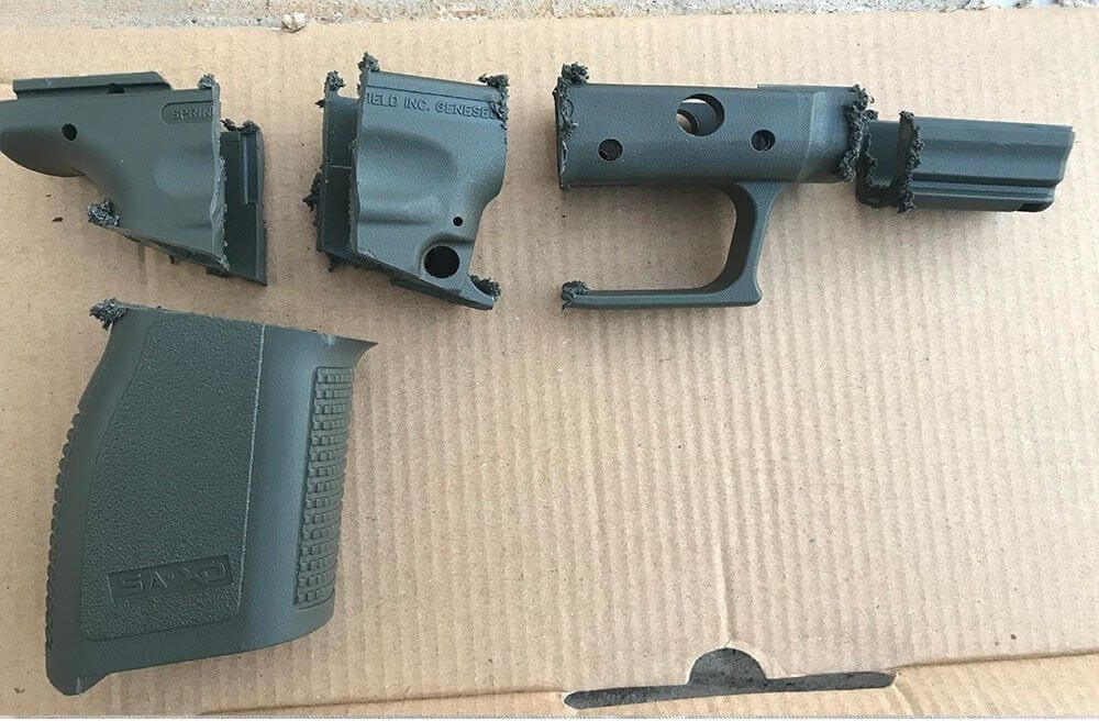 A Springfield Armory XD handgun frame sawed into 5 parts AFTER firearm destruction service completed.